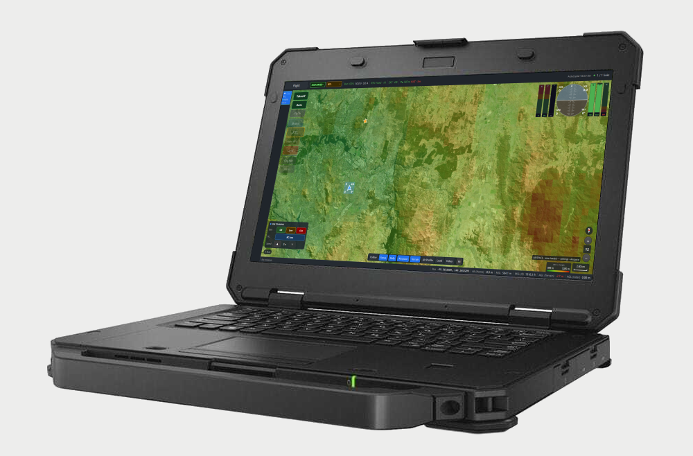 Juno on a rugged laptop: a terrain map with the aircraft's position, the flight modes down the left and the flight instruments at the top right